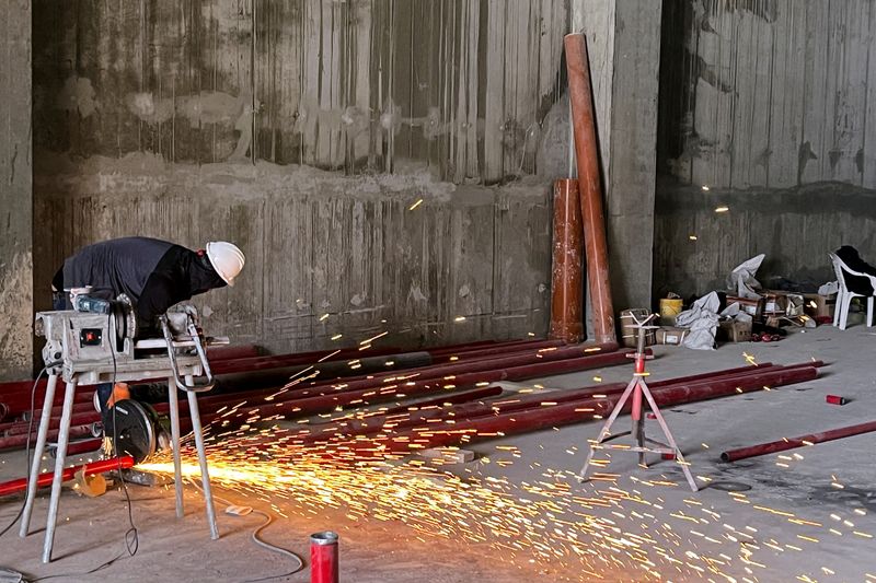 © Reuters. FILE PHOTO: A worker uses a buzz saw at the construction site for a new warehouse in the Har Tuv Industrial Zone in Beit Shemesh, Israel, March 4, 2024. REUTERS/Ari Rabinovitch/File photo