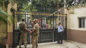 Security personnel stand guard during a raid on the premises of former principal of RG Kar Medical College Sandip Ghosh by CBI in connection with alleged financial irregularities at the institute during his tenure, in Kolkata, Sunday, Aug. 25, 2024. (PTI Photo)